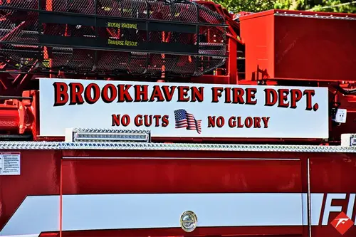 Body side lettering close-up on red panel above compartments