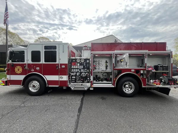 Pierce Saber pumper, officer-side profile view showing pump panel and side compartments