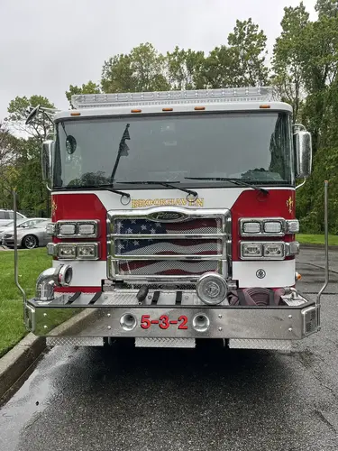 Pumper front view showing grille, bumper intake, and warning lights