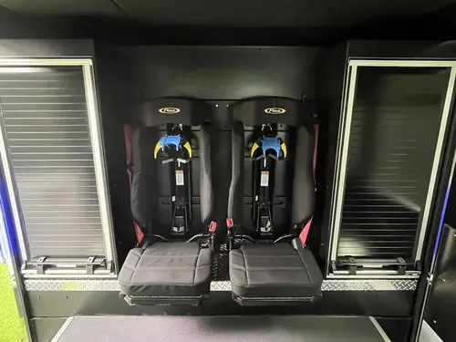 Rear crew seating area showing fold-down SCBA seats and side roll-up storage doors