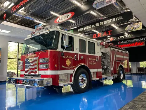 Front-left exterior profile showing pumper in apparatus bay