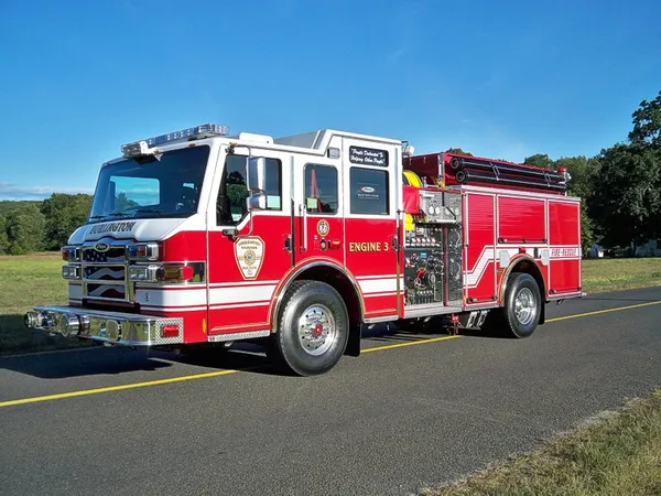 Pumper front-left exterior view showing enclosed cab and side compartments