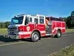 Pumper front-left exterior view showing enclosed cab and side compartments