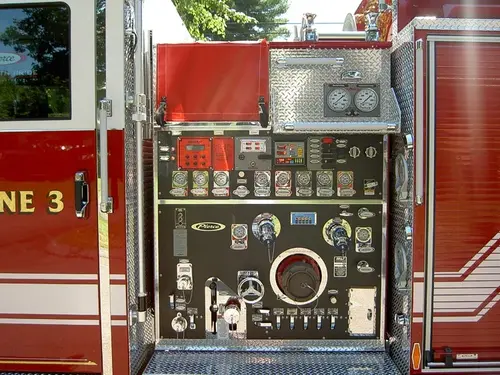 Pump panel close-up showing gauges, valves, and intake connections
