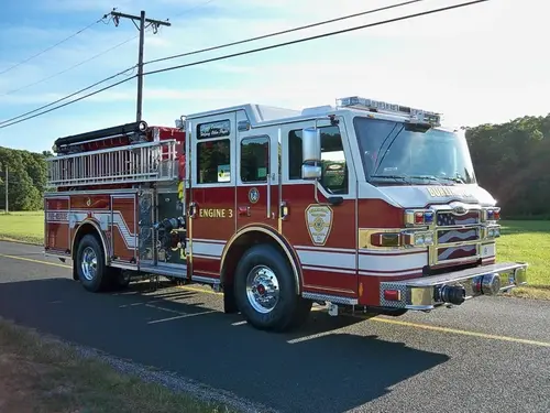 Front-right exterior view showing cab, bumper, and side body