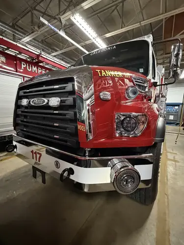 Front view showing grille, bumper, warning lights, and hood badging