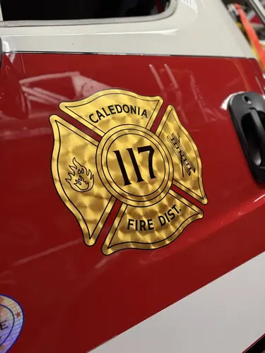 Cab door close-up showing department crest and unit number