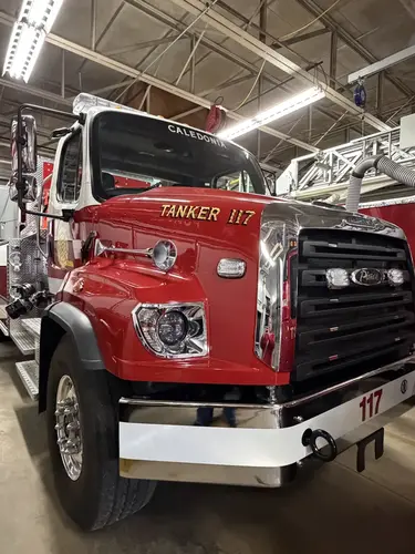 Front-right exterior view showing grille, bumper, and side pump connections