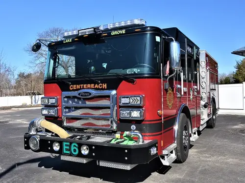 Pumper front-left exterior view showing grille, bumper intake, and crew cab
