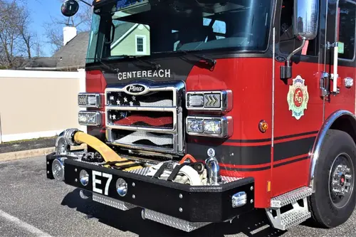 Front bumper close-up showing intake fitting, grille detail, and warning lights