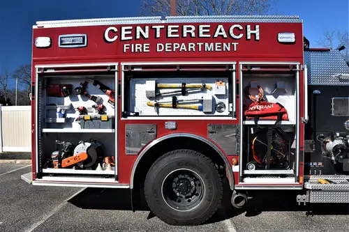 Officer-side compartment view with door open showing hand tools and equipment shelves