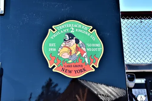 Body emblem close-up showing a circular department logo on a dark panel