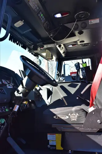 Cab interior view showing front seats, center console, and dashboard area