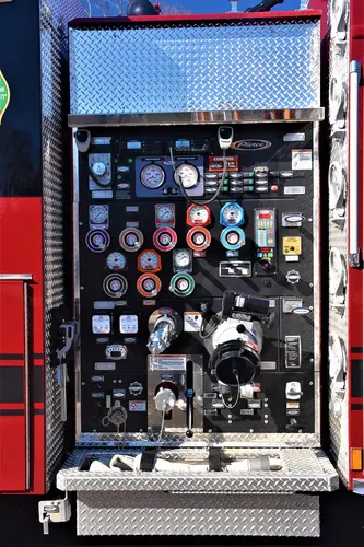 Pump panel close-up showing gauges, valves, and intake controls
