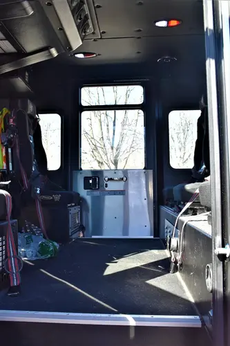 Rear crew cab interior view showing seating, aisle space, and interior paneling