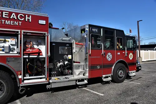 Officer-side profile view with open body compartments and tool storage shelves