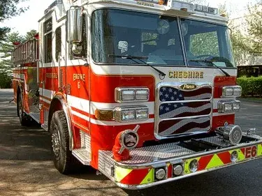 Pumper front-left exterior view showing bumper, cab, and side compartments