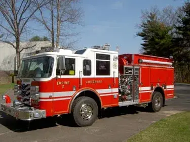 Pumper front-left exterior view showing enclosed cab and side compartments