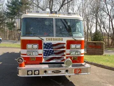 Front exterior view showing grille, bumper, and warning lights