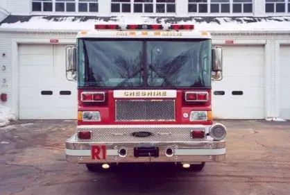 Front exterior view showing grille, bumper, and warning lights
