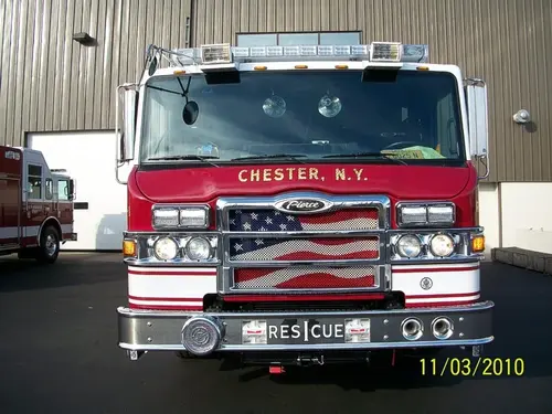 Head-on front view showing grille, windshield, warning lights, and bumper-mounted intake ports.