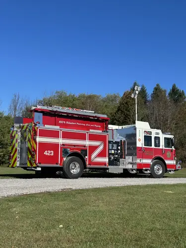 Pierce pumper rear-left profile view showing chevron striping and hosebed area