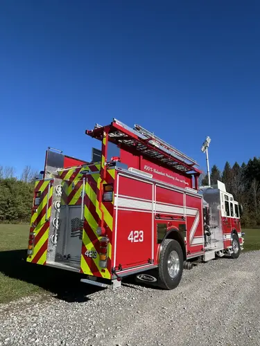 Pierce pumper rear-left view showing chevron rear and side hosebed rails