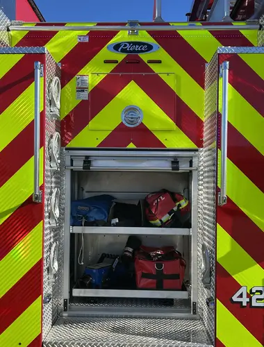 Pierce pumper rear-right exterior view with chevron striping and open rear bay