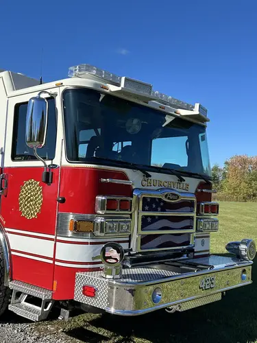Pierce pumper front-right view with sunlight flare and full side body