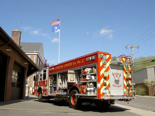 Rear-left exterior view showing chevrons and open side compartment area
