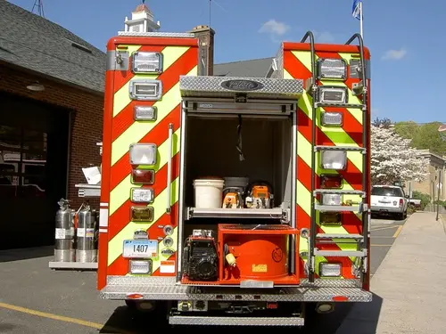 Rear view showing red-and-yellow chevrons with open rear center compartment