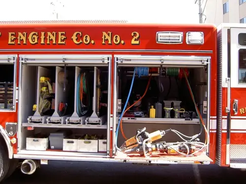 Open side compartment showing mounted hand tools and equipment shelves