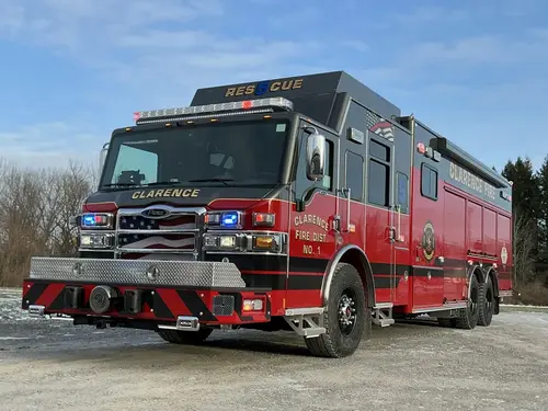 Aerial ladder truck front-left exterior view showing cab, grille, and bumper