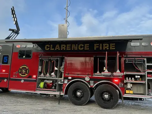 Driver-side full profile showing tiller body and nested aerial ladder