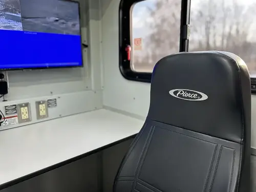 Command seat and desk view with monitor and side window