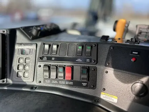 Dashboard switch bank close-up with labeled rocker controls
