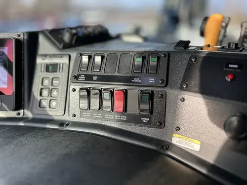 Dashboard control panel close-up with rocker switches and warning button