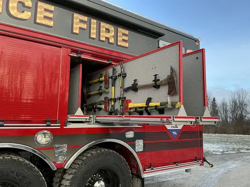 Front-left cab and mid-body view showing side paneling and wheel area
