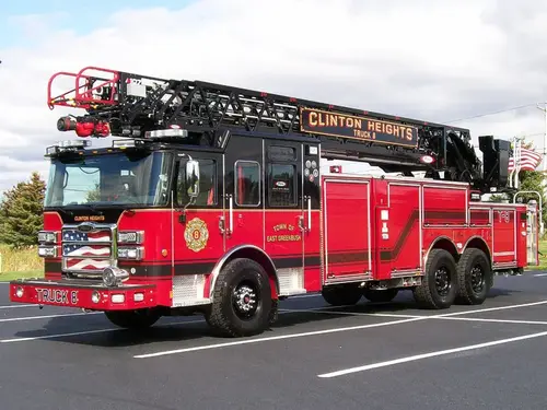 Tower ladder truck front-left exterior view showing ladder sections and cab