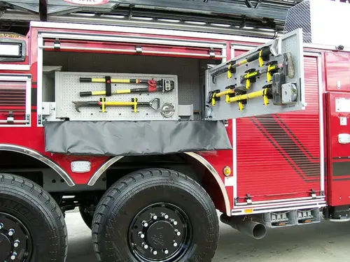 Open side compartment showing pull-out long-tool rack and storage channel