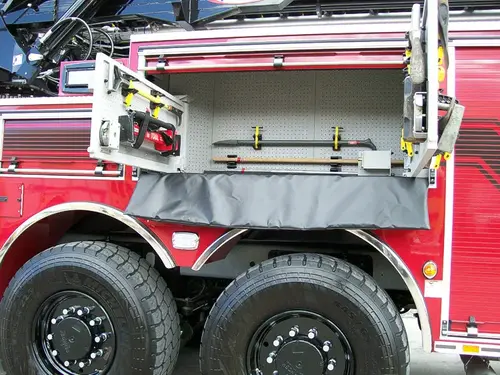 Open side compartment showing extended tool rack above rear wheel set