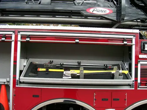 Open side compartment showing mounted hand tools in horizontal rack