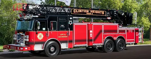 Tower ladder truck side profile view with ladder sections above body