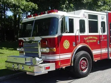 Pumper front-left exterior view showing enclosed cab and side compartments