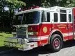 Pumper front-left exterior view showing enclosed cab and side compartments