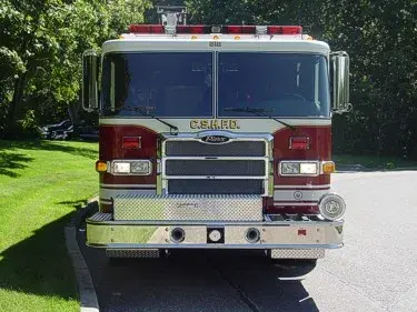 Front exterior view showing grille, bumper, and warning lights
