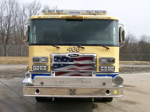 Front exterior view showing grille, bumper, and warning lights