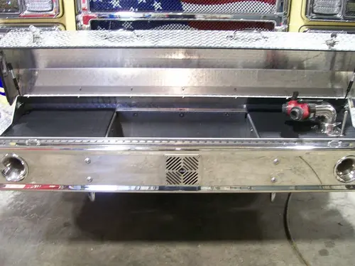 Front bumper tray close-up showing recessed storage compartment
