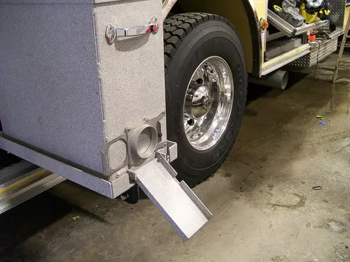 Lower body close-up showing fold-down step near rear wheel