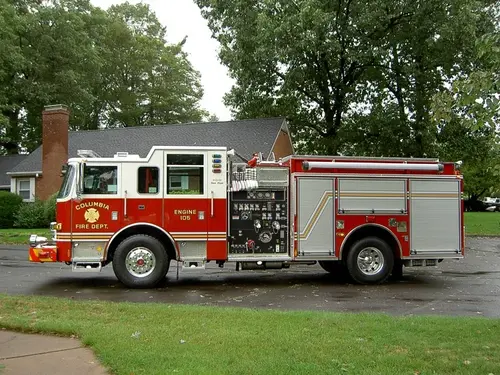 Driver-side profile view showing pump panel area and side compartments